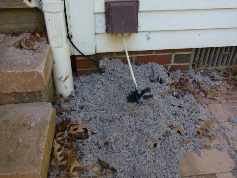 Lint outside under a dryer vent after dryer vent cleaning service by Urbana Dryer Vent Cleaning in Frederick, MD