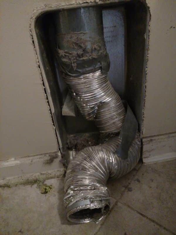 Picture of a mangled transition duct from behind a dryer. This was from a dryer vent repair job in Gaithersburg, MD.