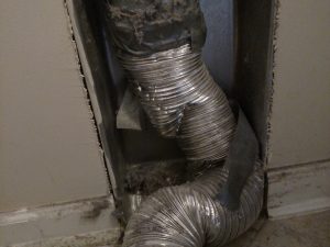 Picture of a mangled transition duct from behind a dryer. This was from a dryer vent repair job in Gaithersburg, MD.