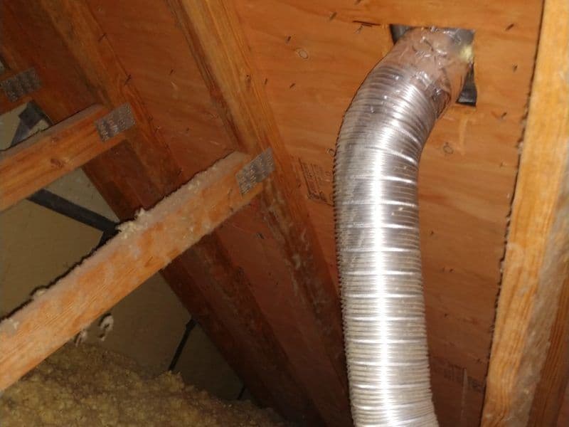 Picture of semi-rigid dryer vent ducting in an attic. This is a code violation. This was from a dryer repair job in Germantown, MD.