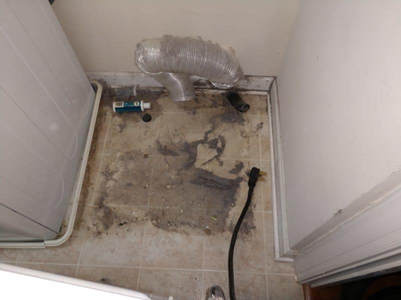 Picture of a dirty floor under a dryer in Urbana, MD