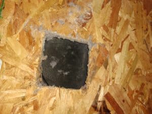 Picture of a dryer vent roof penetration that was covered with tar paper and shingles. This caused a dryer fire and was from a dryer vent repair job in Charles Town, WV