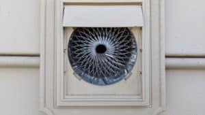 Picture of a metal screen installed behind the louver flaps of a bathroom vent.