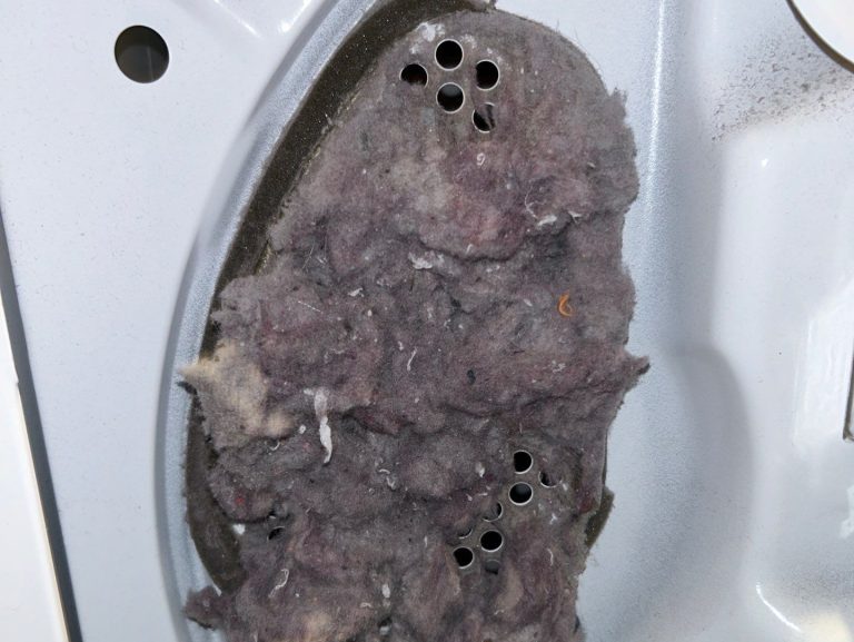 Picture of dryer heater duct outlet vent. The vent is clogged with lint. This needs dryer cleaning service